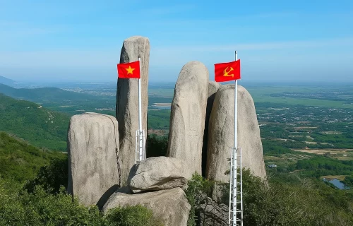 Panoramic view from Minh Dam Mountain with hiking trails, historic monuments, and the Ho Tram coastline in the distance.