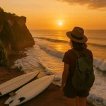Traveler watching sunset from Uluwatu cliffs with scenic ocean view.