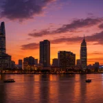 Ho Chi Minh City skyline at sunset with the Saigon River and Bitexco Tower